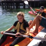 A woman in a kayak participating in a small business marketing workshop.