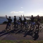 A group of people on bicycles posing for a picture during a small business marketing workshop.