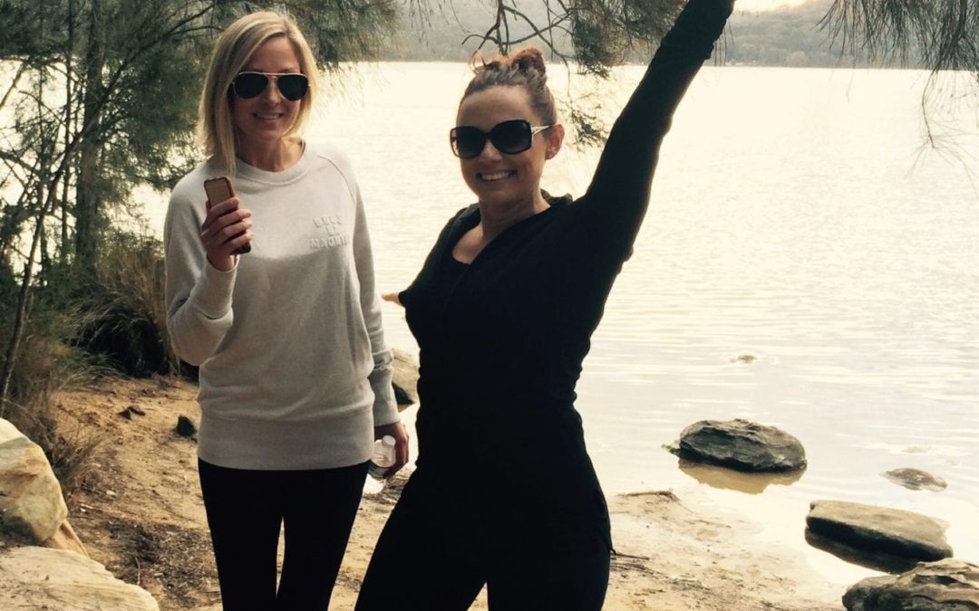 Two women hosting a marketing workshop near a body of water as part of their small business marketing plan.