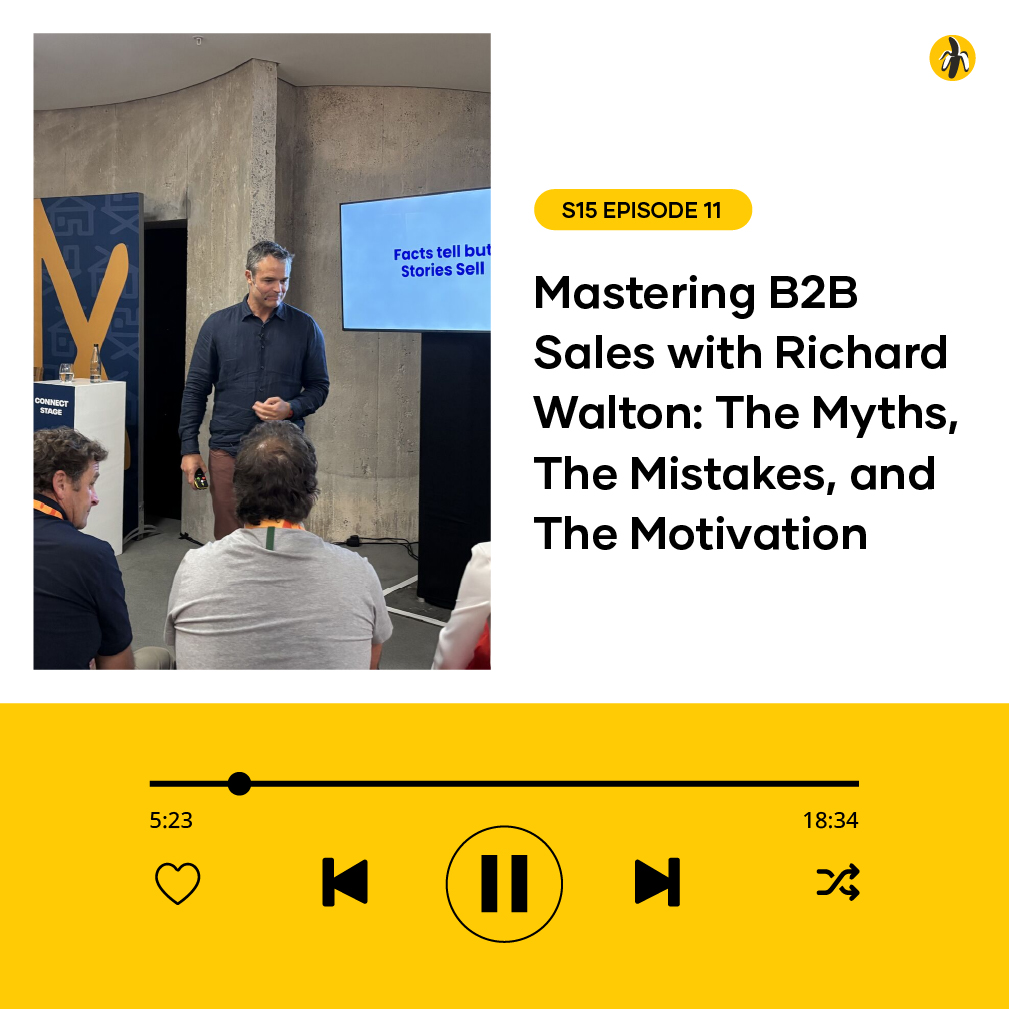 A man stands in front of a small audience next to a screen displaying a sales-related slide, promoting a podcast episode on mastering B2B sales with Richard Walton.